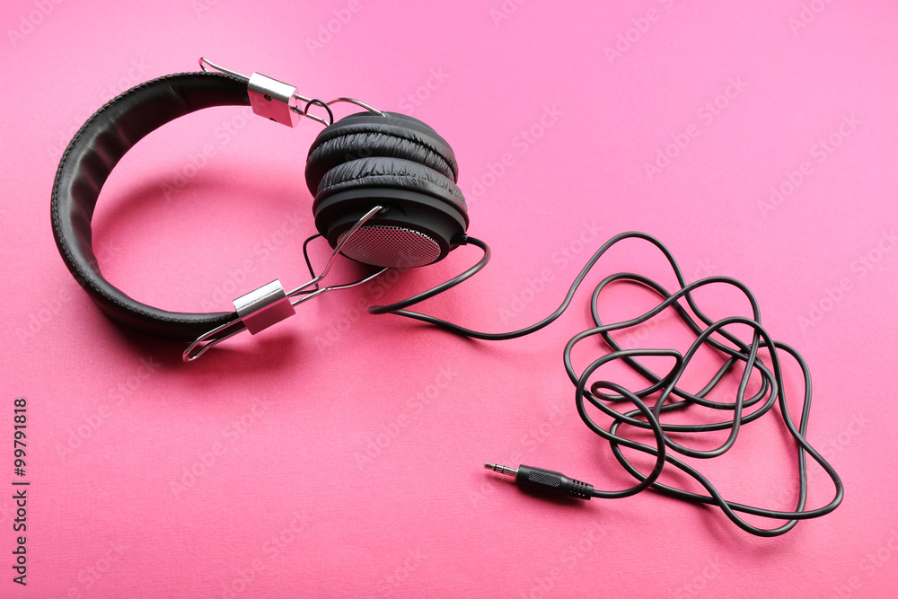 Black headphones on pink background Black headphones on pink background