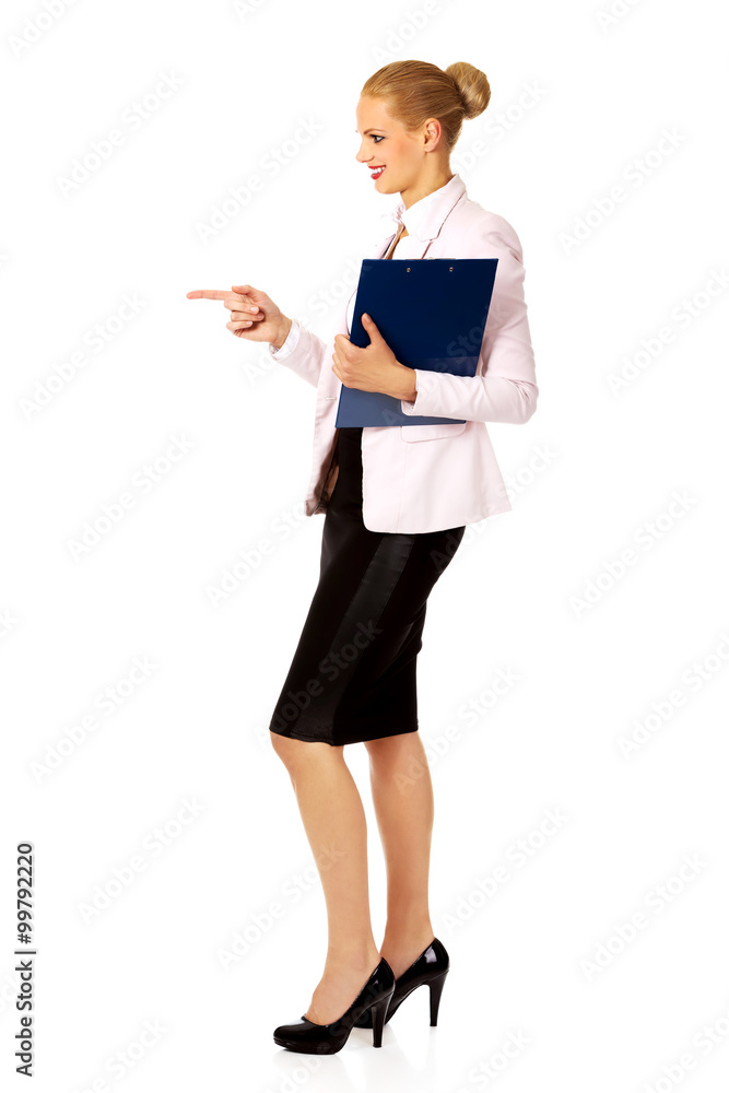 Business woman holding a binder and talking with someone Business woman holding a binder and talking with someone