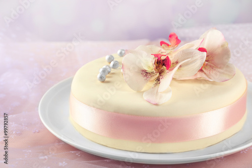 Cake with sugar paste flowers  on light background