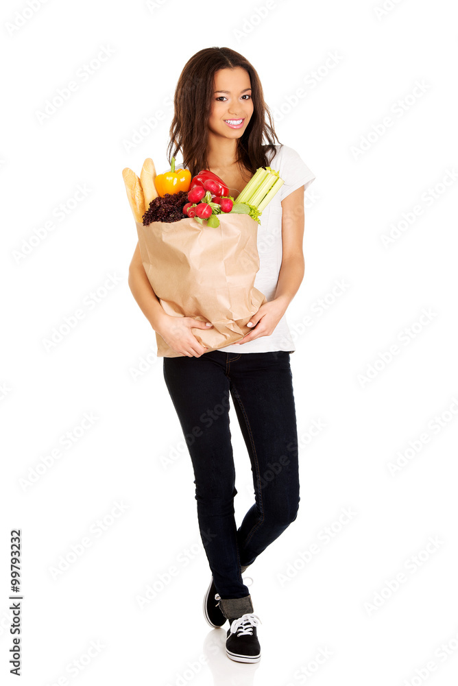 Young woman with grocery and vegetables. Young woman with grocery and vegetables.
