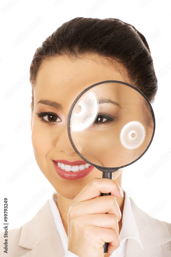 Businesswoman looking through magnifying glass. Businesswoman looking through magnifying glass.