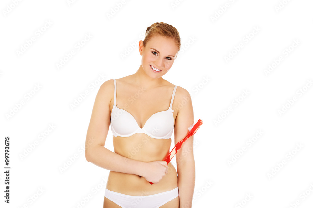 Obraz premium Woman holding red huge toothbrush