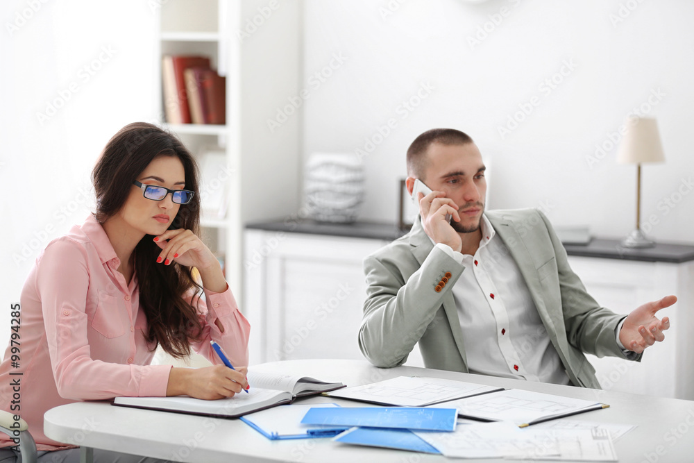 Fototapeta premium Two estate agents, in bright office