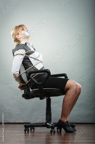 Foto Businesswoman bound by contract with taped mouth.