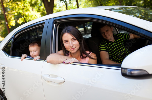 Family sitting in the car looking out windows © davit85