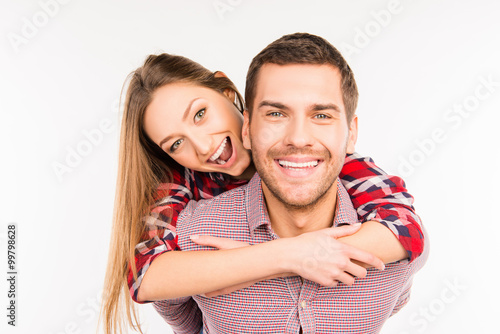 Happy young man piggybacking his girlfriend.