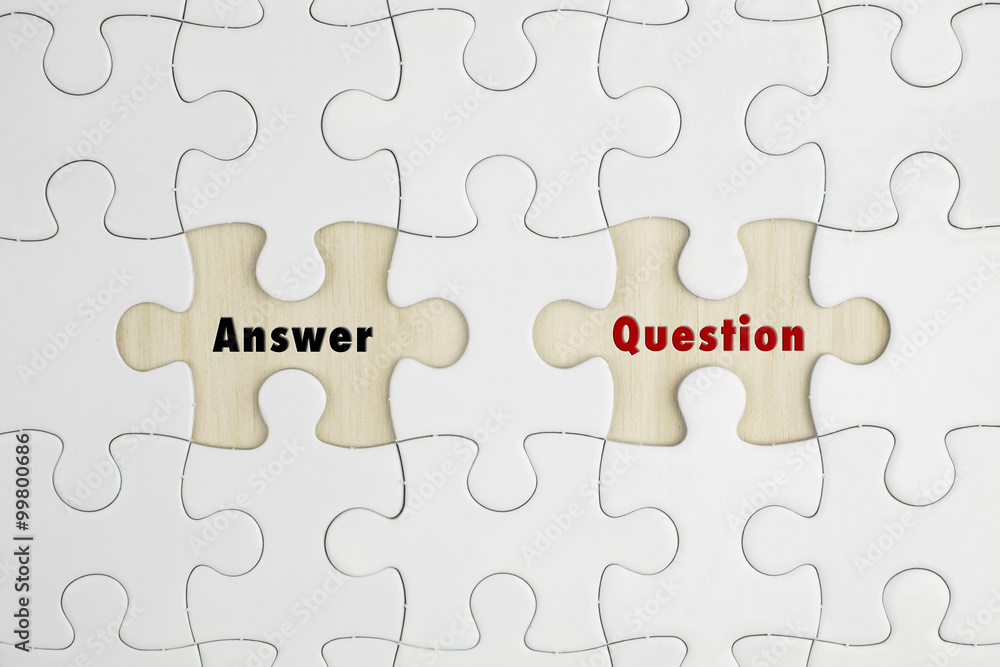 Jigsaw puzzle on wood background with a word ANSWER and QUESTION Jigsaw puzzle on wood background with a word ANSWER and QUESTION