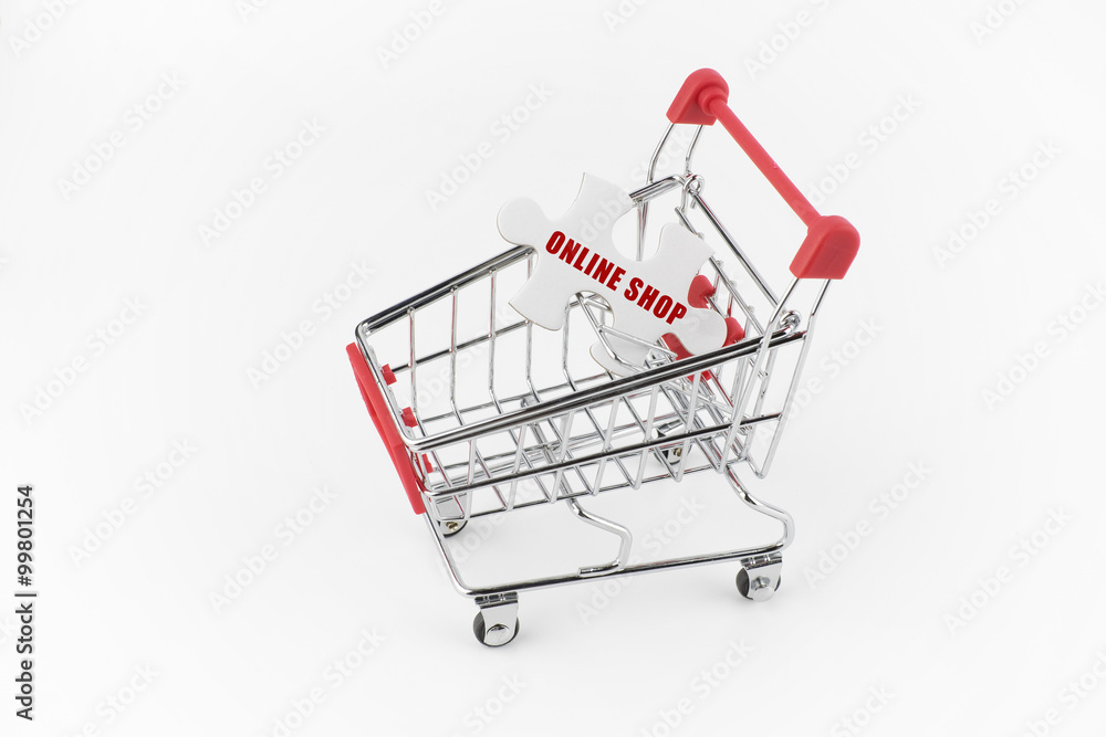 Shopping cart with word online shop on a piece of puzzle over white background Shopping cart with word online shop on a piece of puzzle over white background