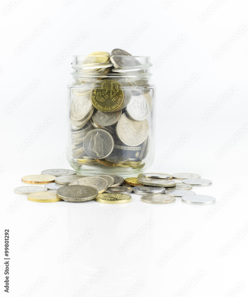 Glass jar with full of coins over white background Glass jar with full of coins over white background