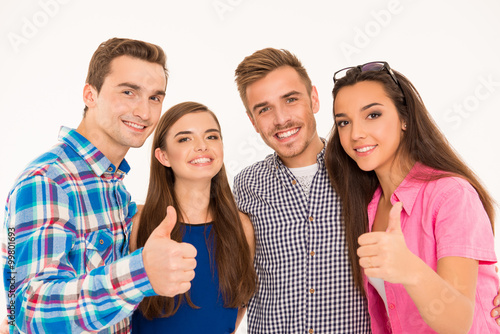 Happy cheerful group showing thumbs up