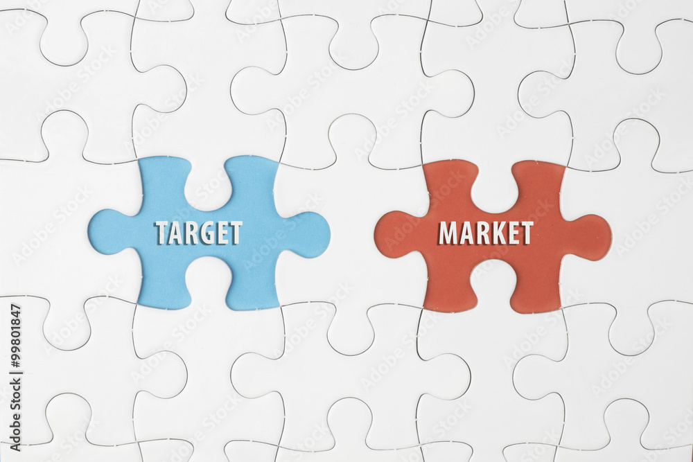 Jigsaw puzzle on color paper background with a word TARGET and MARKET Jigsaw puzzle on color paper background with a word TARGET and MARKET