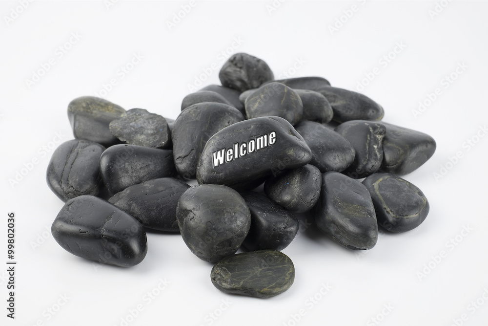 Black pebble with Welcome word on white background Black pebble with Welcome word on white background