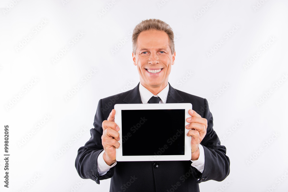 Confident aged man in business suit showing a screen of tablet Confident aged man in business suit showing a screen of tablet