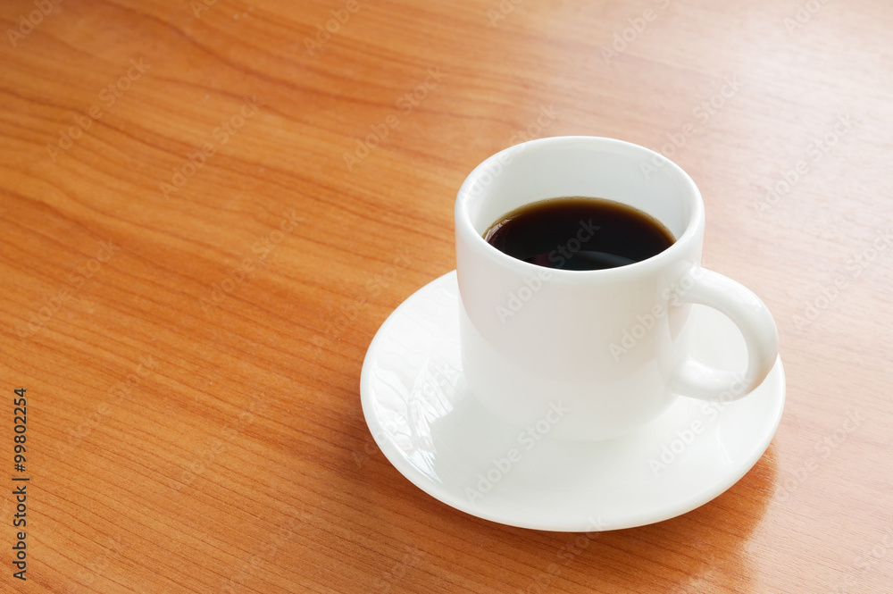 Fresh Black Coffee in a White Ceramic Cup on a Wooden Table Fresh Black Coffee in a White Ceramic Cup on a Wooden Table