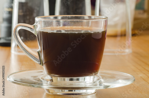 The cup of hot coffee on wooden background in the morning