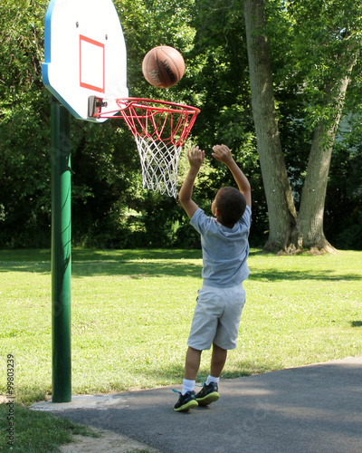 Child Playing Basketball Outdoors