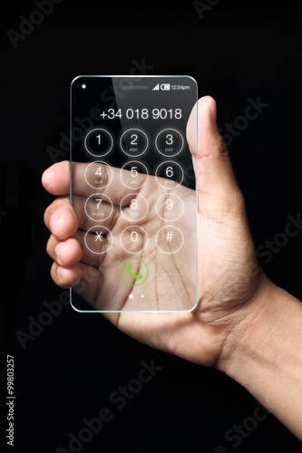 Wallpaper Mural Transparent smartphone with hand on dark background. Torontodigital.ca