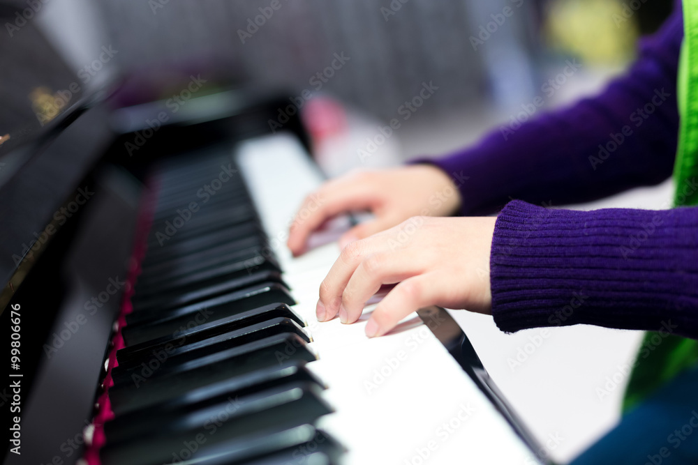Fototapeta premium Asian cute boy playing piano at home