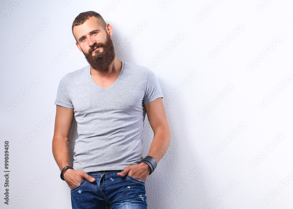 Portrait of handsome man standing, isolated on grey background Portrait of handsome man standing, isolated on grey background