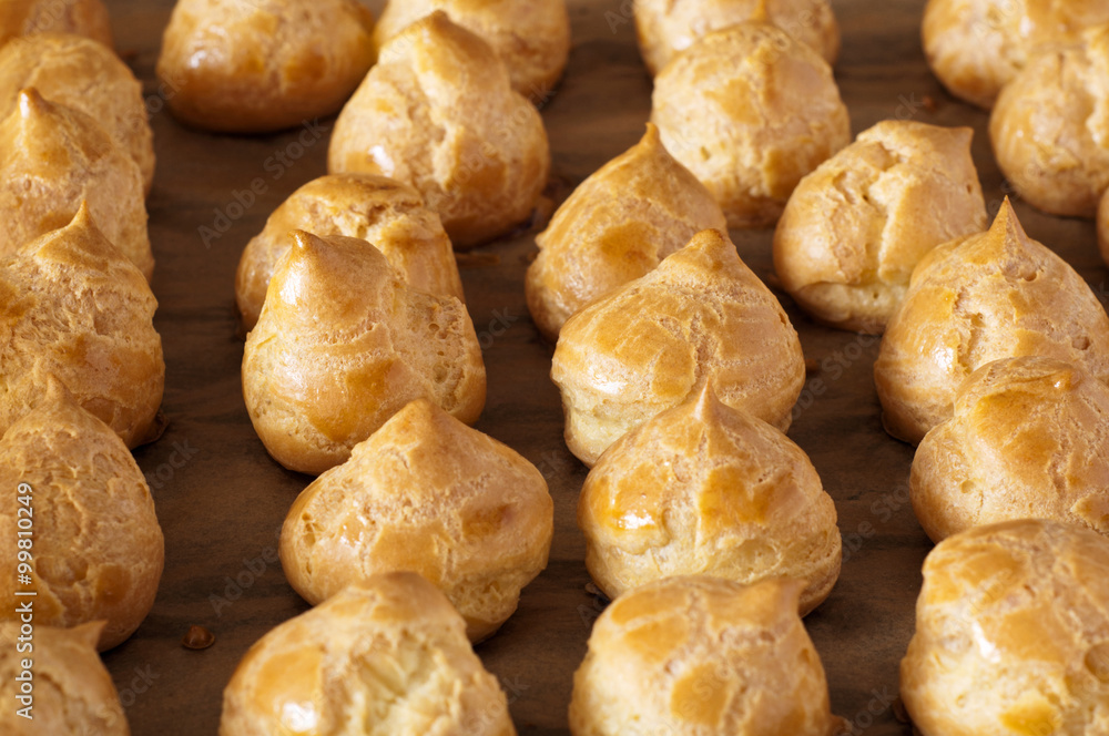 profiteroles stuffed on a baking tray profiteroles stuffed on a baking tray