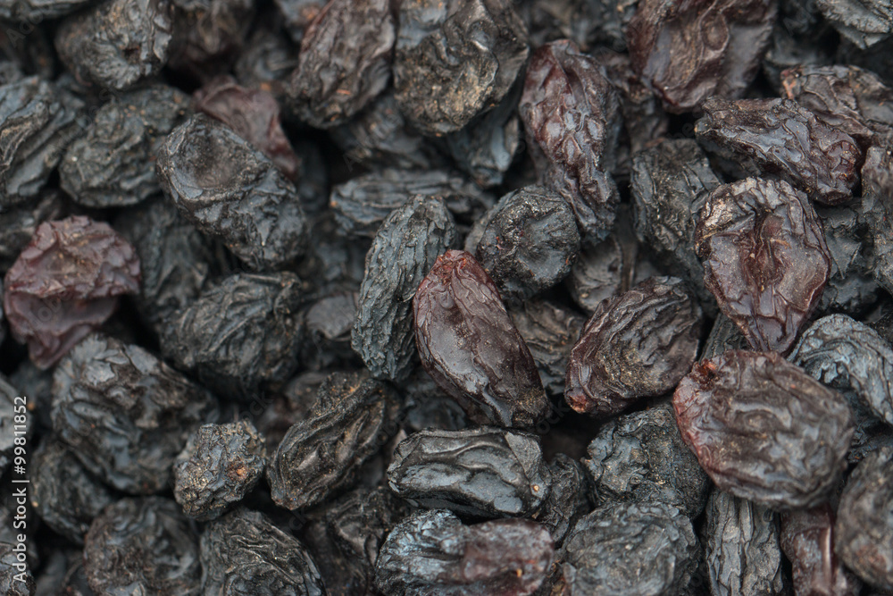 Black dried grapes on a white background Black dried grapes on a white background
