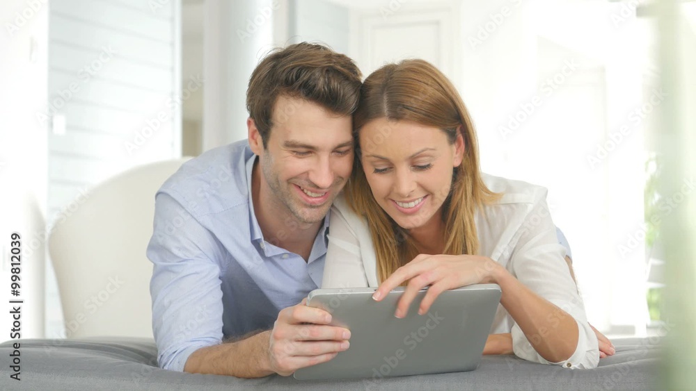 Couple having fun playing with tablet Couple having fun playing with tablet