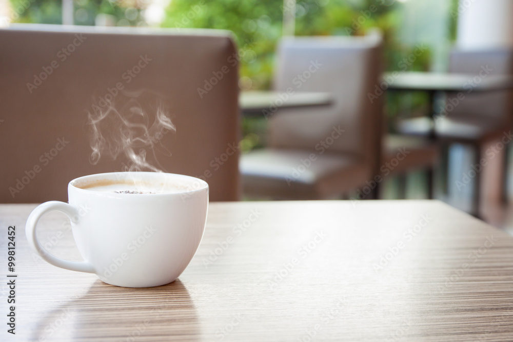 Hot coffee on a wooden table in a coffee shop. Hot coffee on a wooden table in a coffee shop.