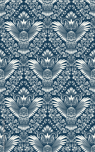 Damask seamless pattern with owl silhouette. Vintage repeating background. Floral ornament of blue tones in baroque style.