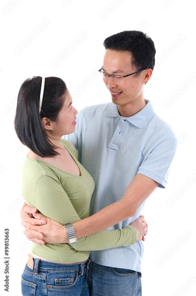 Happy young Asian couple isolated in home background. Happy young Asian couple isolated in home background.
