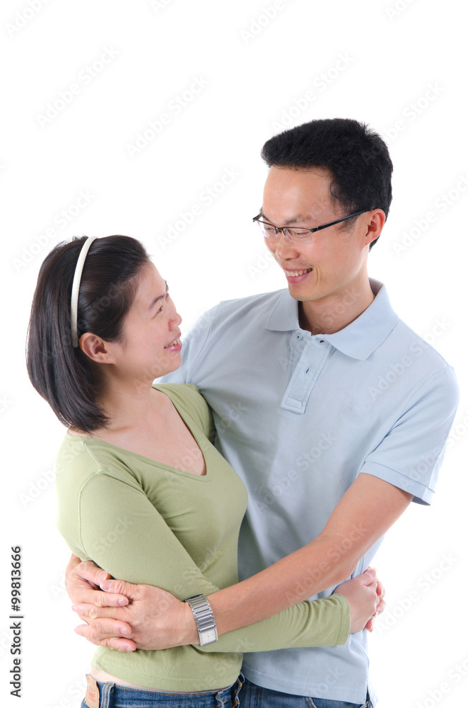 Happy young Asian couple isolated in home background. Happy young Asian couple isolated in home background.