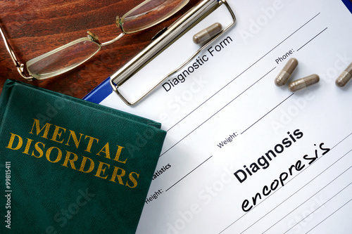 Foto Encopresis  concept. Diagnostic form and book on a table.