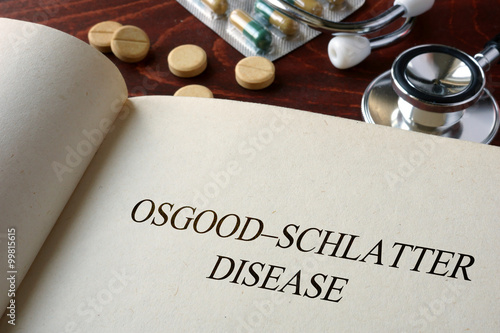 Book with diagnosis Osgood–Schlatter disease and pills. Medical concept.