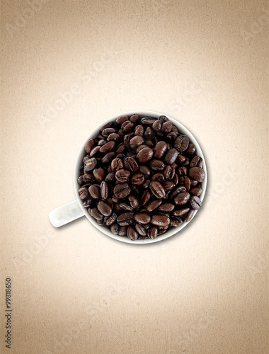 coffee beans in cup on paper texture  vintage background 