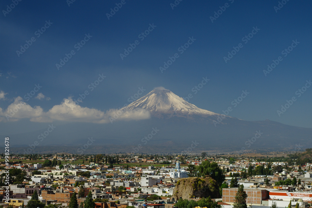 Popocatepetl Volcano Towering over the town of Puebla, Mexico Popocatepetl Volcano Towering over the town of Puebla, Mexico
