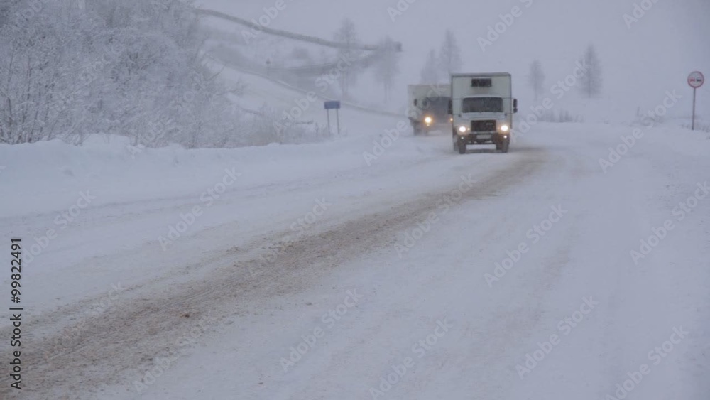 Winter snowfall. Traffic flow on highway Winter snowfall. Traffic flow on highway