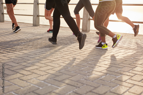 Runners training together on seaside promenade