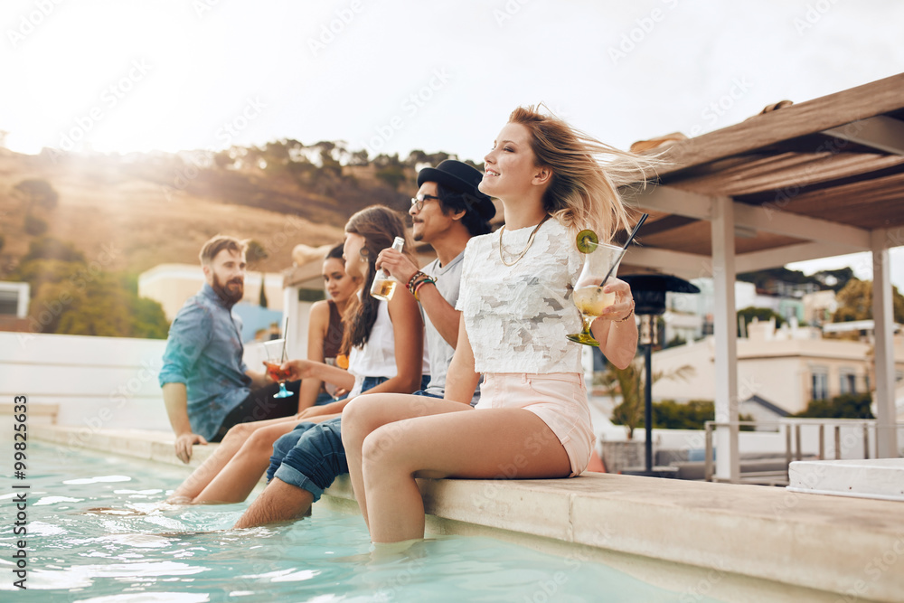 Friends partying by poolside