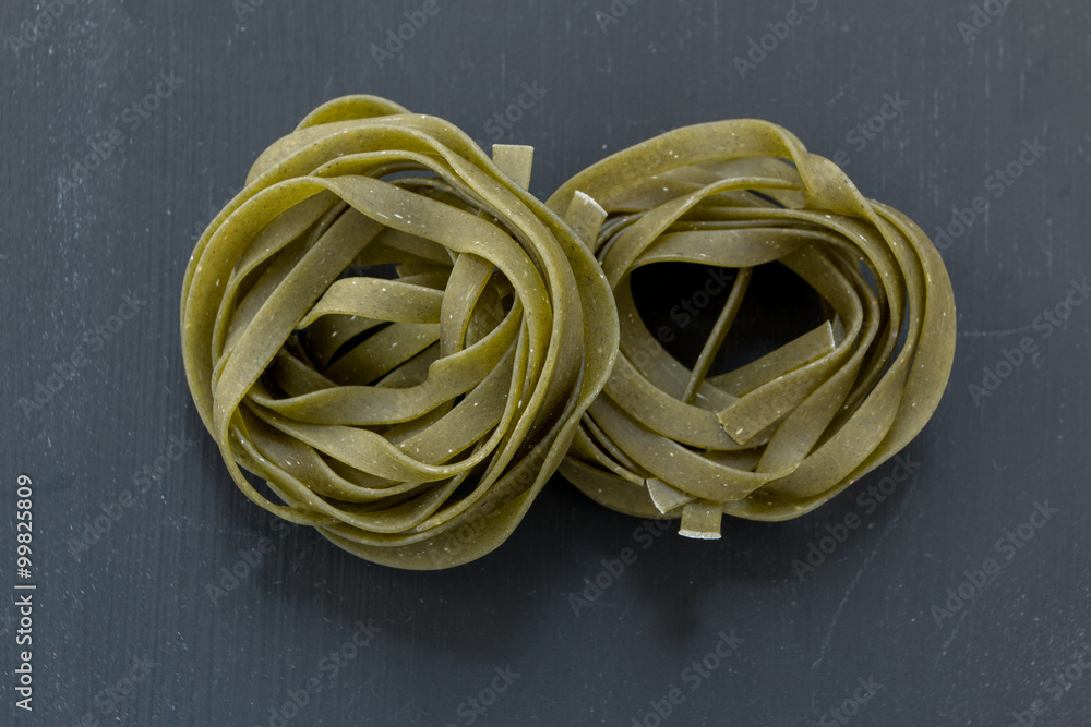 Raw homemade pasta on black background. Top view Raw homemade pasta on black background. Top view