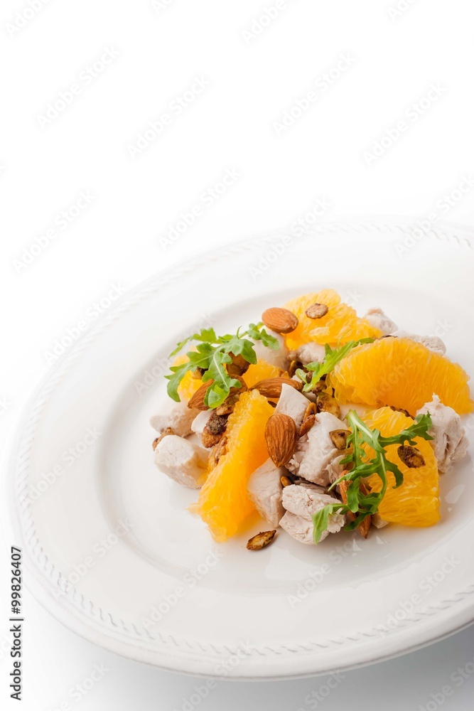 Salad with chicken and orange on the white plate vertical Salad with chicken and orange on the white plate vertical