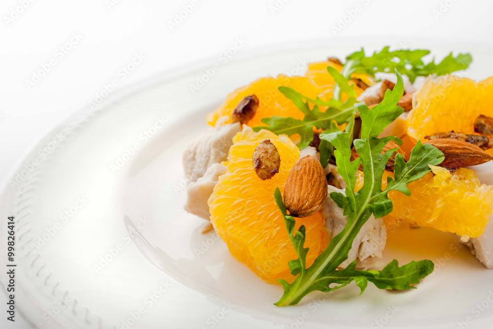 Salad with chicken and orange on the white plate horizontal