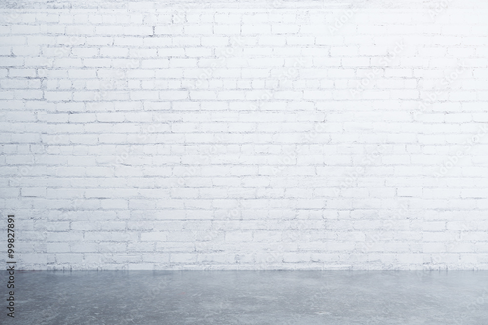 White brick wall and concrete floor in empty room White brick wall and concrete floor in empty room
