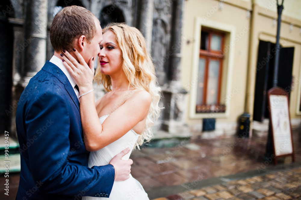 Wedding couple in the rain at old city Lviv