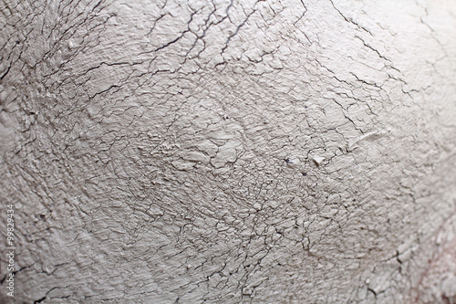 Closeup of female face with clay facial mask as texture or background