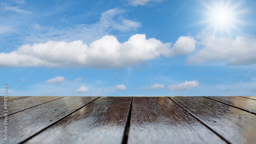 Wooden table texture with blue sky background.