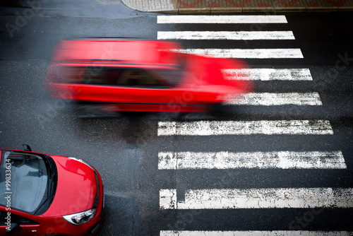 two red cars on the pedestrian crossing photo