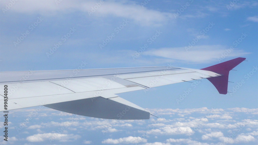 Airplane window view to the blue sky and clouds Airplane window view to the blue sky and clouds