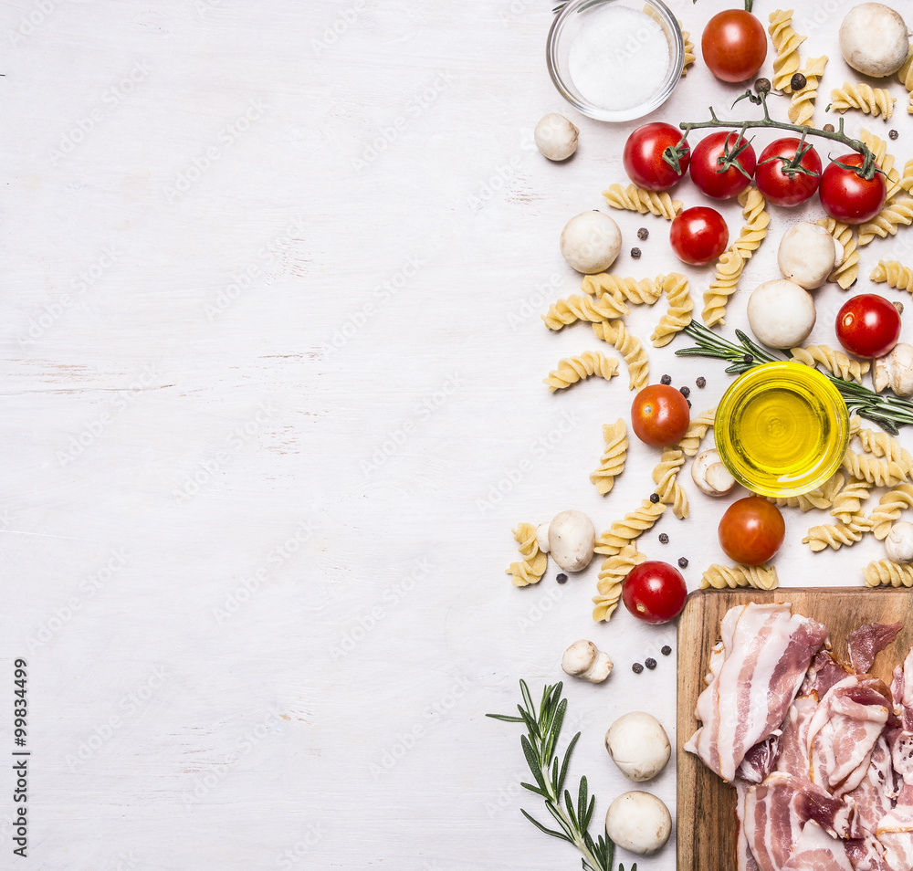 Ingredients for cooking fusilli pasta with bacon vegetables, spices and herbs border, place for text on wooden rustic background top view Ingredients for cooking fusilli pasta with bacon vegetables, spices and herbs border, place for text on wooden rustic background top view