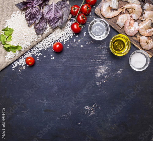 Ingredients for risotto with prawns, vegetables, spices, white wine border, place for text on wooden rustic background top view