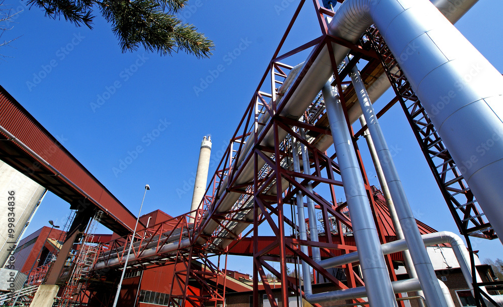 Industrial zone, Steel pipelines and valves against blue sky