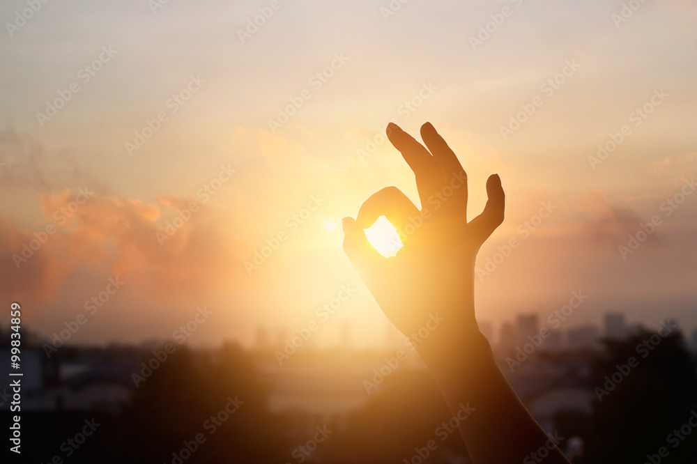 hand in the sunset, one sign of meditation in buddhism, soft  focus